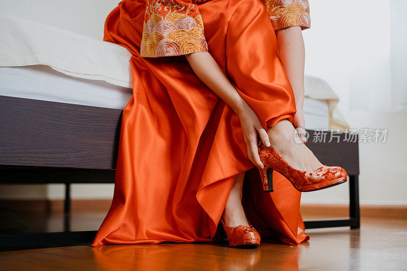 An Asian Chinese bride wearing red high heels